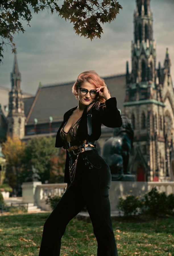 Gothic woman posing near gothic church.
